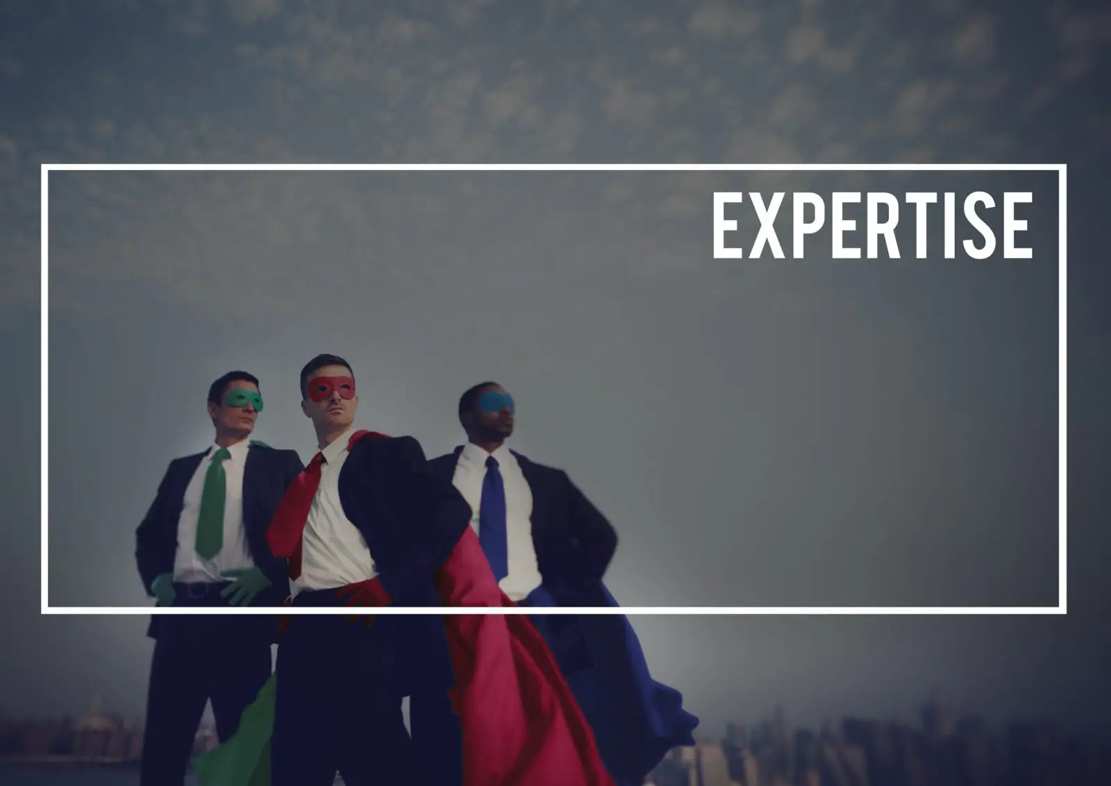 Three men in business suits pose like superheroes wearing capes and masks to show their expertise.