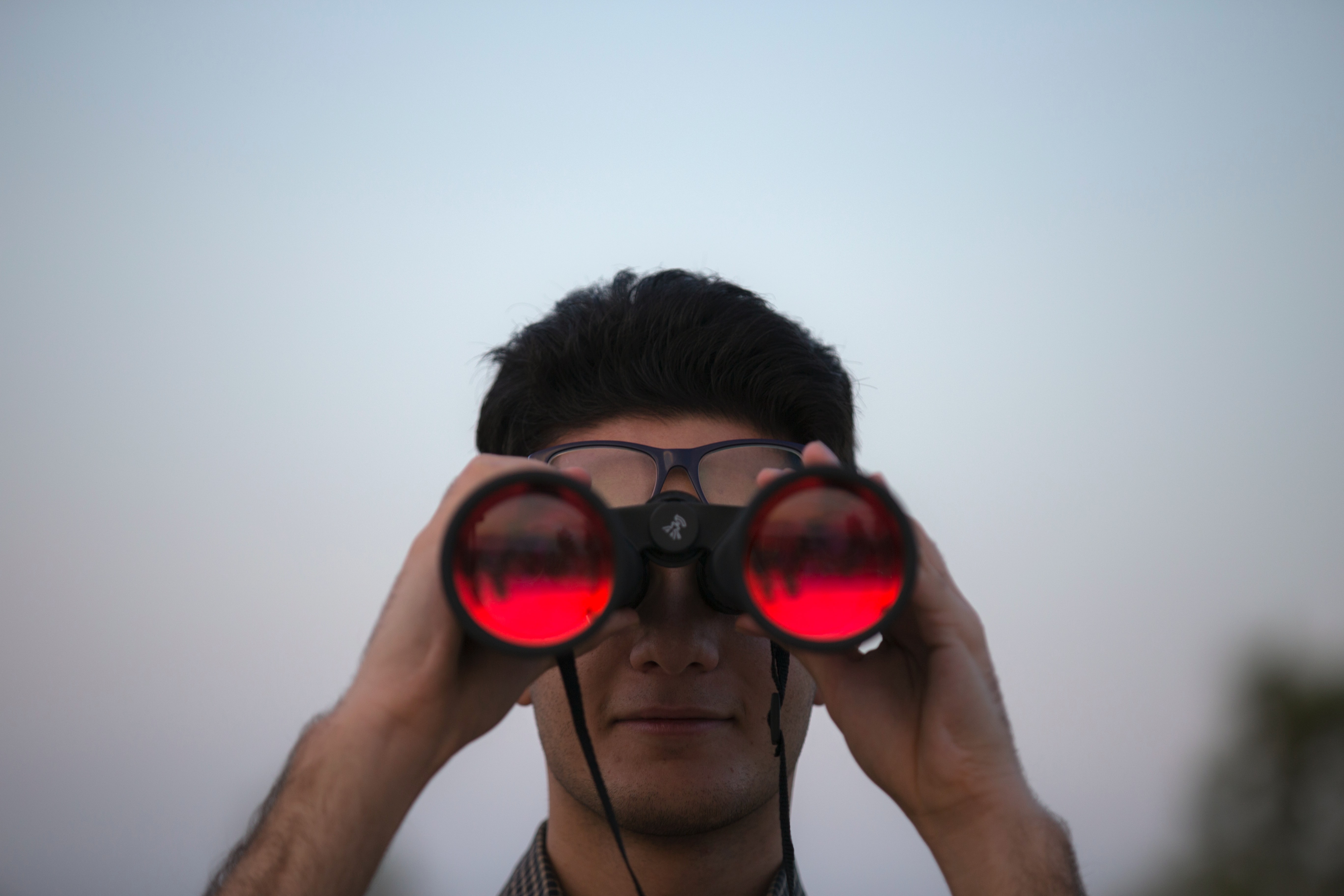 A man viewing the world through binoculars.