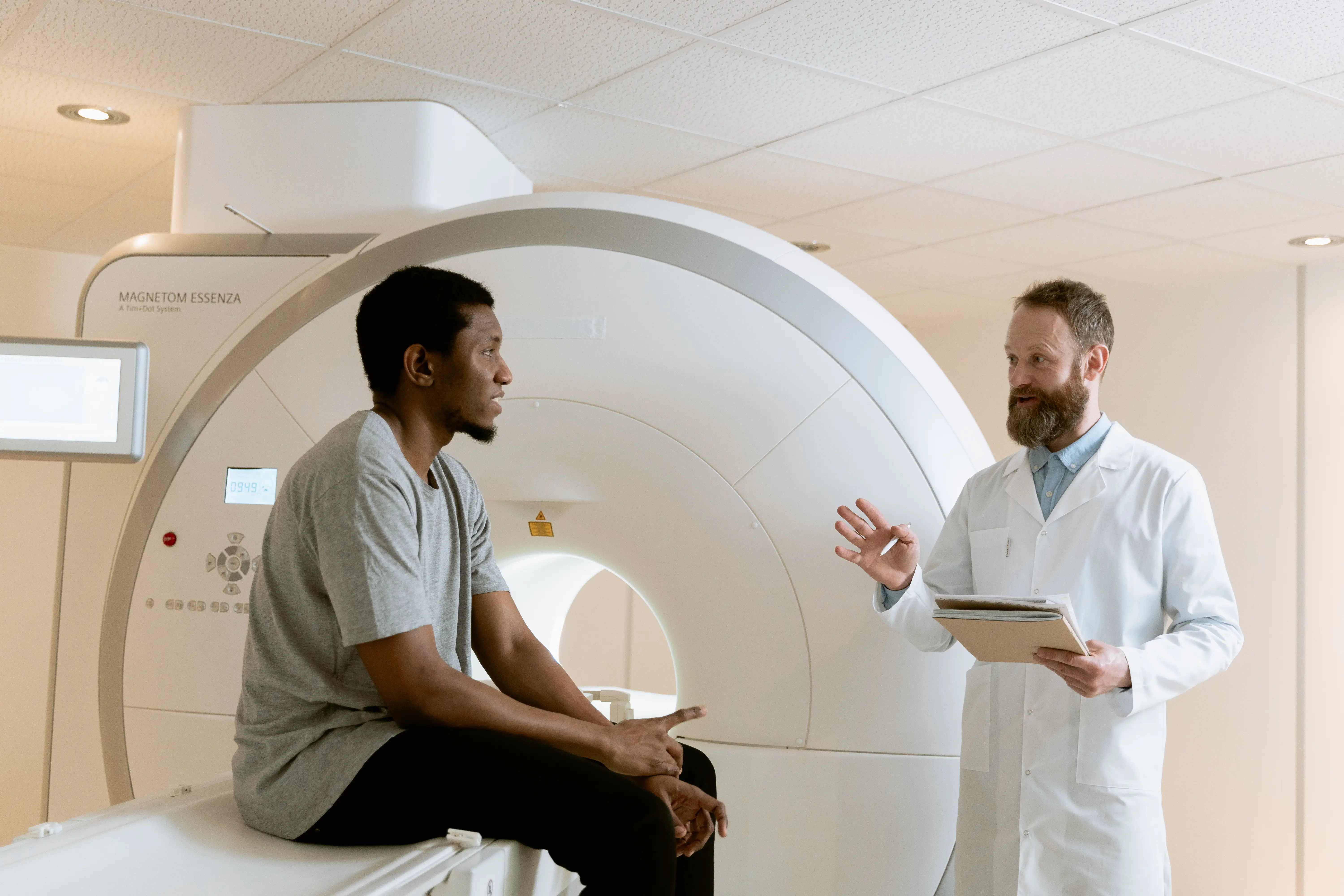 Doctor talking with patient near an MRI machine