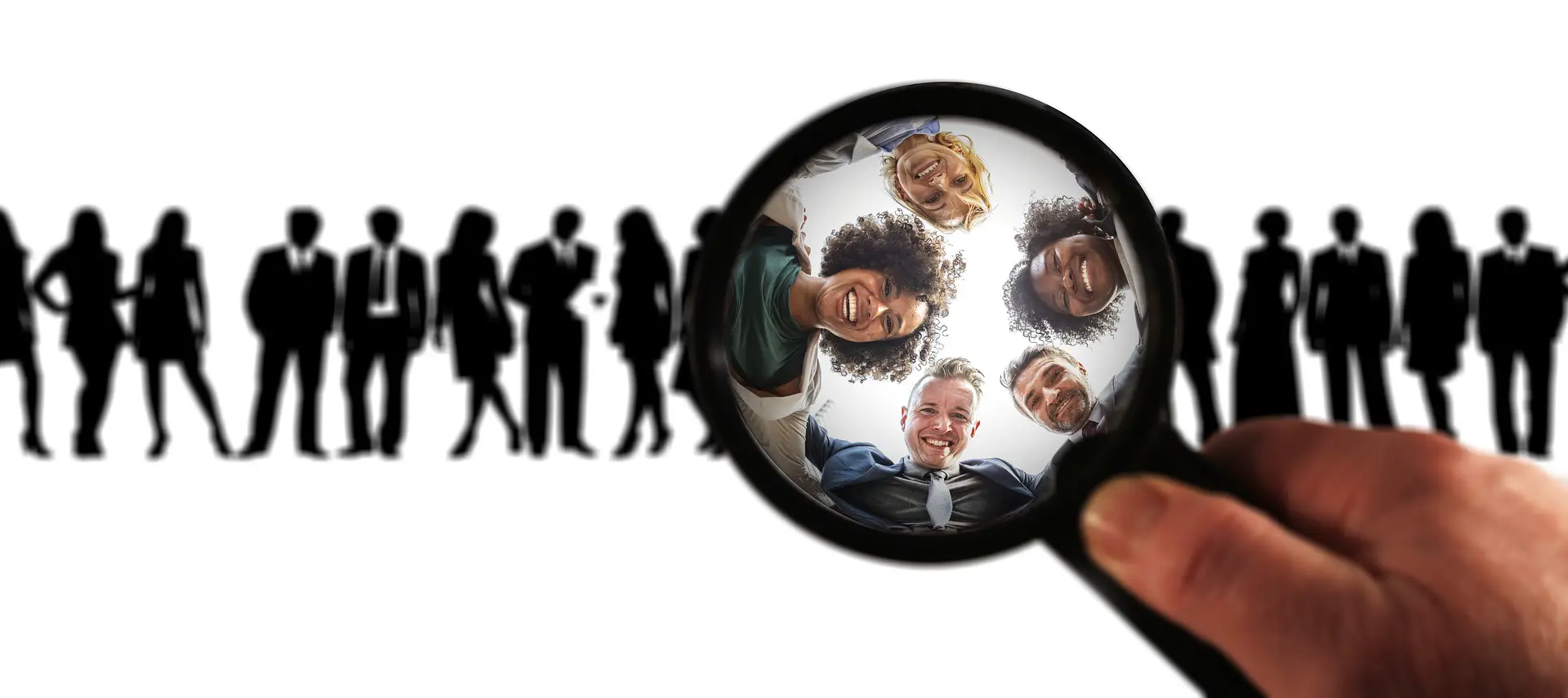 A magnifying glass pointing out a few people in a crowd.